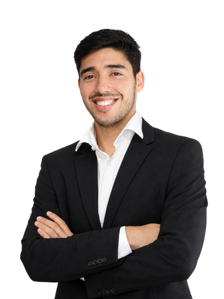 Nicolás Alvarado de terno negro y camisa blanca, sonriendo con los brazos cruzados